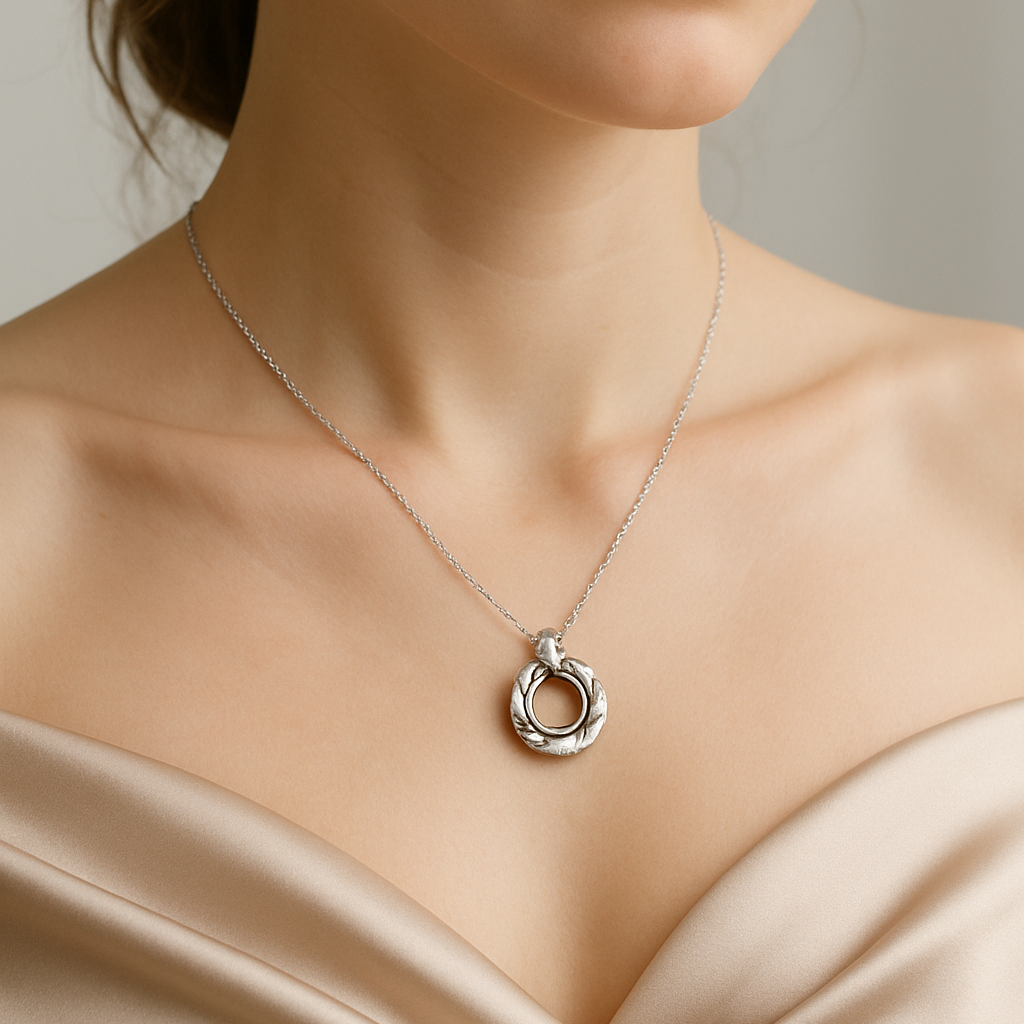 Necklace with a pendant worn by a person against a neutral background
