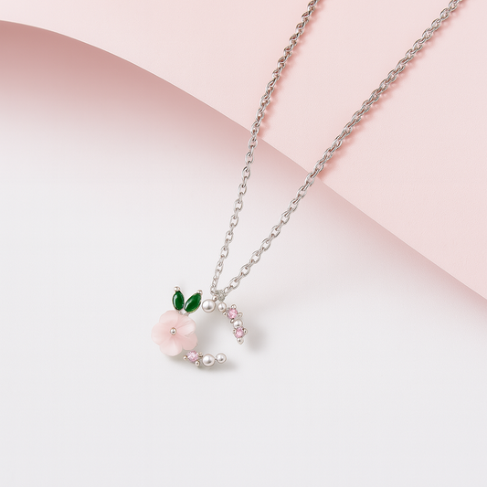 Necklace with a heart-shaped pendant featuring a pink flower on a light pink background