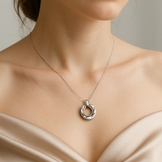 Necklace with a pendant worn by a person against a neutral background