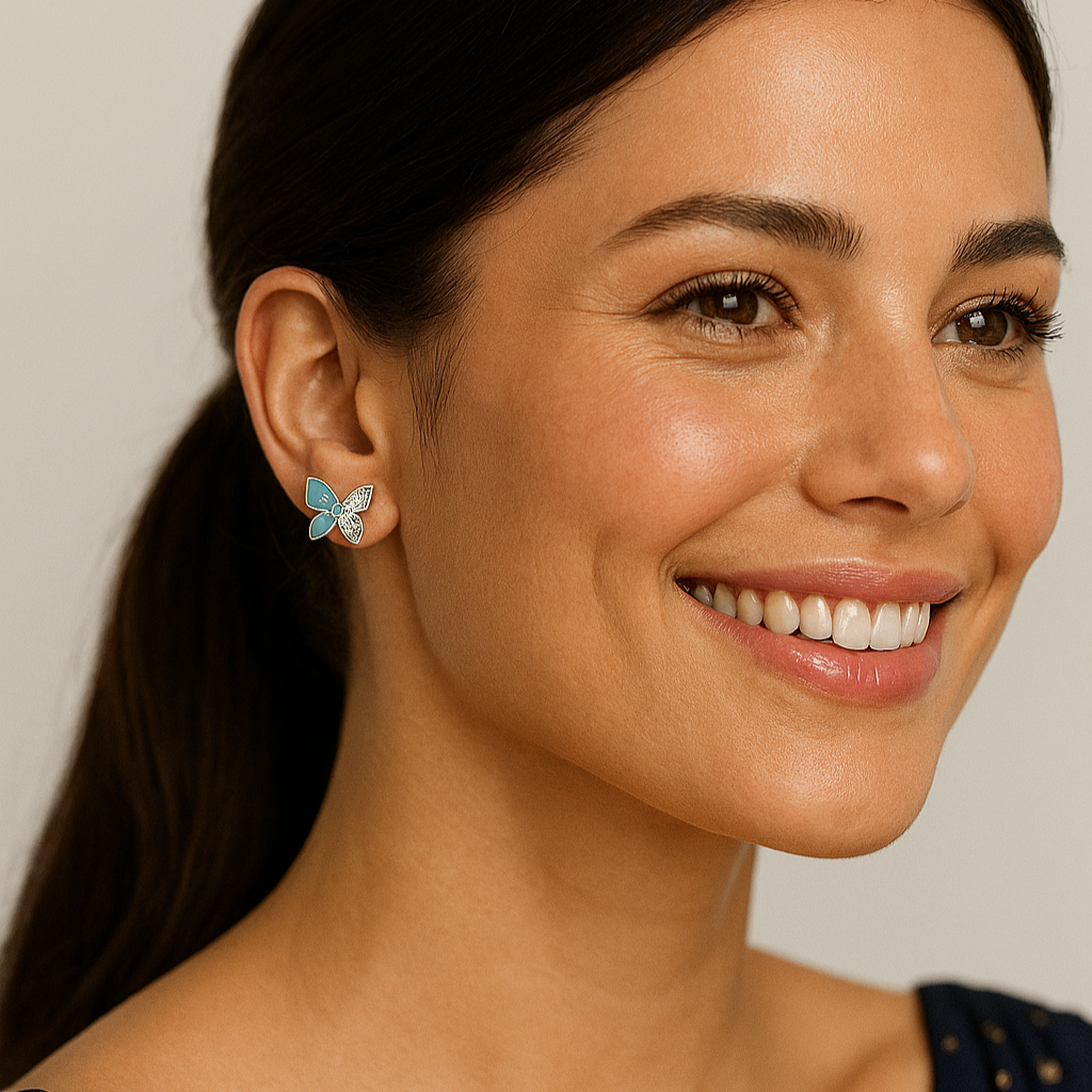 Woman wearing a blue earring with a neutral background