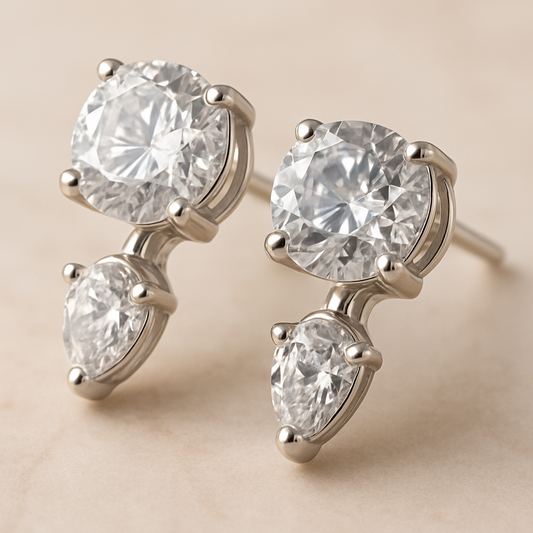 Pair of diamond earrings on a beige background